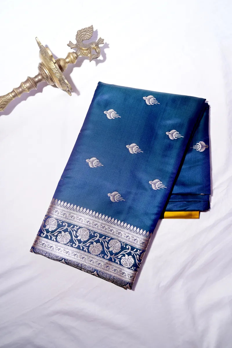 Peacock Blue Banarasi Katan Silk Saree with Silver Zari Butis & Floral Border (RLSS-269)