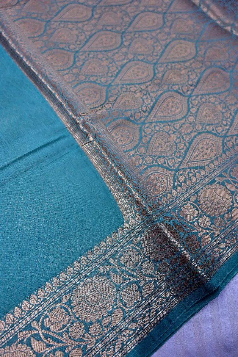 Vibrant Teal Silk Saree featuring Classic Woven Zari Border & Textured Body(RLSS-210)